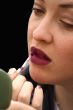 applying lipstick - over black