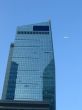 Corporate building with a plane on the blue sky