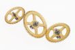 three old gold-coloured cogwheels