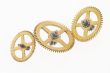 three old gold-coloured little cogwheels