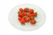 Strawberries on a glass dish, isolated on white