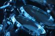 Drum set, lit by blue