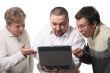 Three men with notebook
