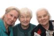 Three old women smiling