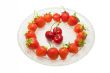 Strawberries and cherries on glass dish, isolated