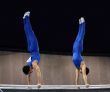2 gymnasts on parallel bars