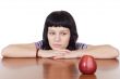 girl watching a red apple