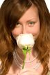 The girl smells a rose