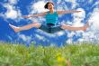 girl jumping to blue summer sky