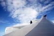 Plane wing with white clouds