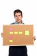 Holding the corkboard with notes
