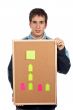 Holding the corkboard with notes