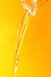 Jet of oil on a yellow background