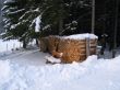 Bank in front of wood pile