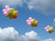 Multicolored colourful ballons in cloudy blue sky