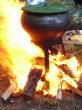 cooking with black pot on opened wood fire