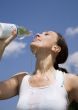 Young woman trinking water outdoors