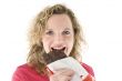 Young blond woman eats chocolate