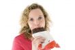 Young blond woman eats chocolate