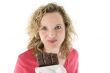 Young blond woman eats chocolate