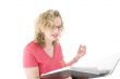 Attractive blonde with glasses checking a folder