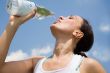 Young woman trinking water outdoors