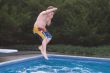 Boy Jumping In a Pool