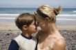 Smiling Boy and  happy mom in the beach