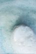 White soap in foam on a blue background