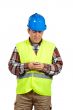 Construction worker sending sms