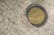 lost euro coin in beach sand