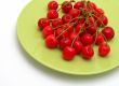 Cherries on the green plate