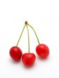 Three cherries on white background