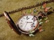 old golden clock on vintage background with many green butterfli