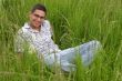 Smiling young man in the grass