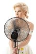 housewife with fan playing pop star