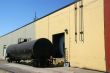 Black tank car, on railroad siding