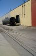 Black tank car, on railroad siding
