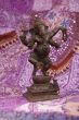 Bronze Ganesha dancing, on purple