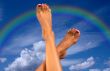 legs over sky with clouds and rainbow