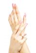 two hands with pink acrylic nails