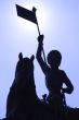 Silhouettee of a statue against blue