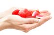 hands full of red bonbons