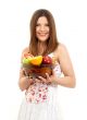 brunette girl holding cup of fruits