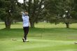 Woman golfer teeing off