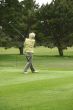 Woman golfer teeing off