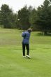 Woman golfer teeing off