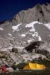Yellow tent in alpine meadow