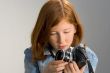 Girl with old SLR photo camera