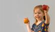 Baby girl with two apples (Focus on yellow apple)
